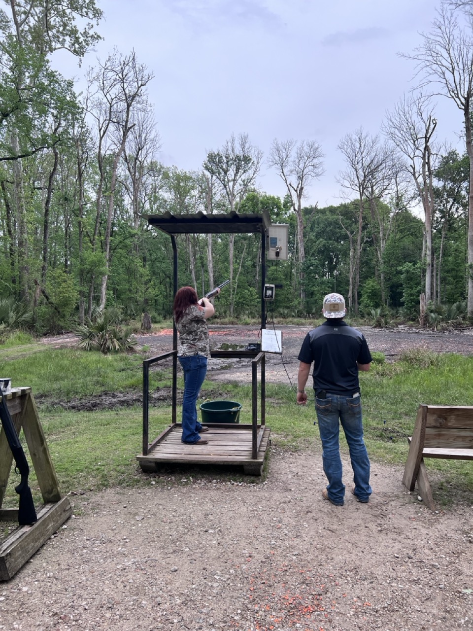 Shooter aiming at clay target at Titan Roofing skeet shoot competition